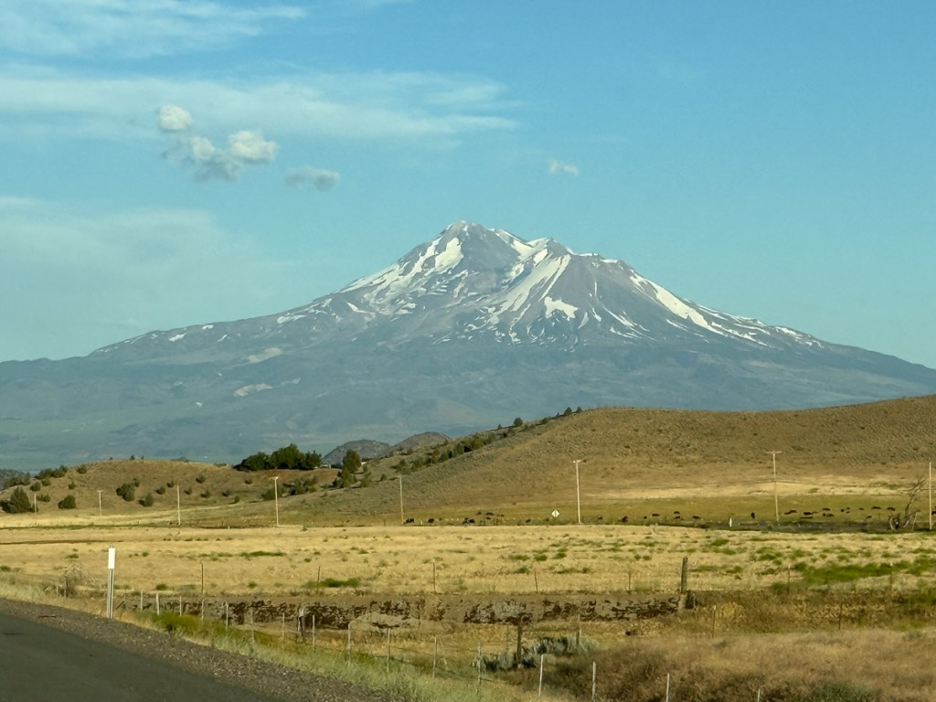 Mt. Shasta with dry hills in front.