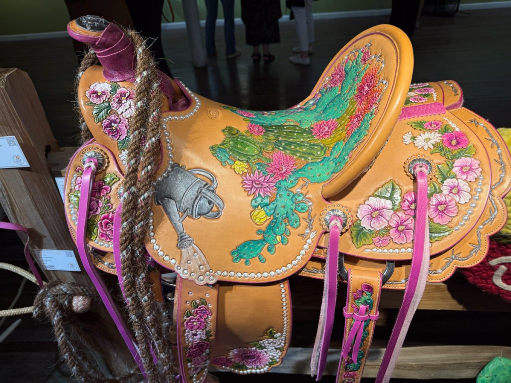 Western saddle with design of flowers and cactus tooled on the leather. 
