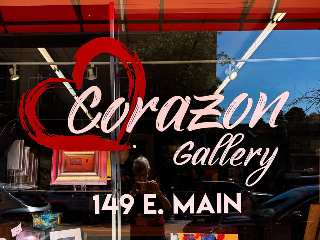 Store window that says Corazon Gallery 149 E. Main.