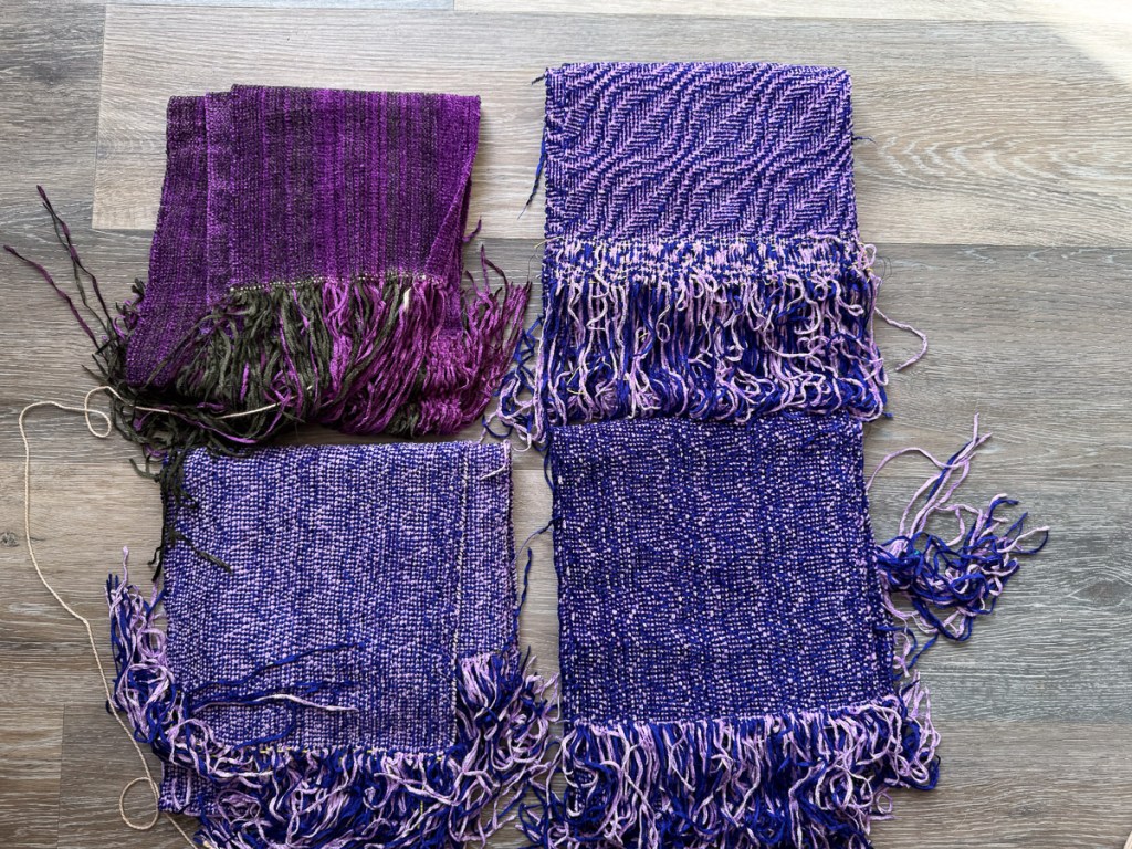 Four handwoven purple chenille scarves that need to have fringe twisted.