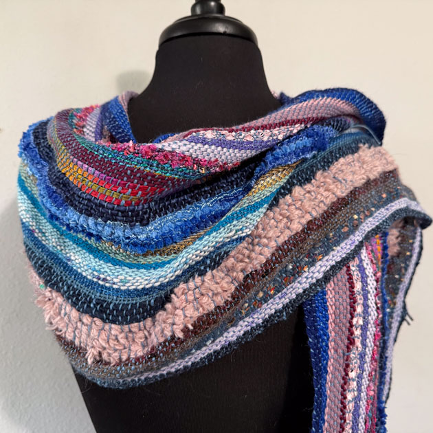 Colorful striped scarf on a mannequin.