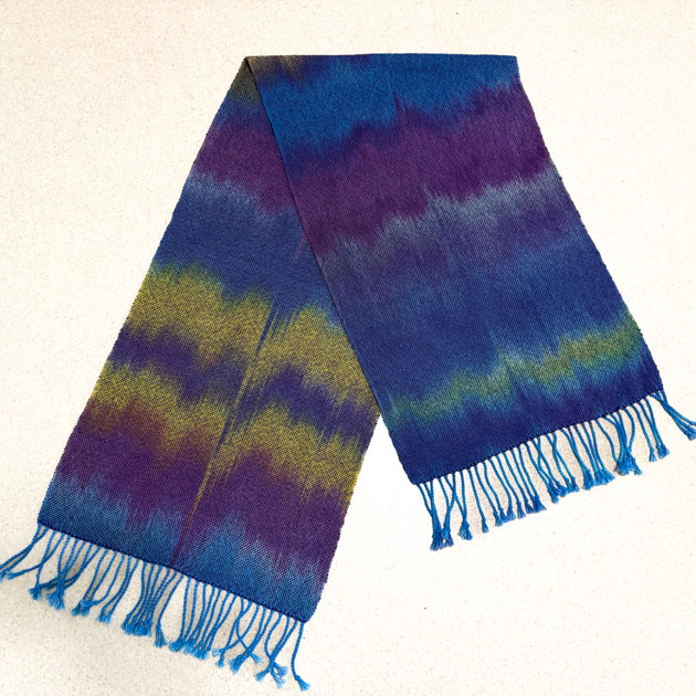 Shawl in blue, purple, and gold.