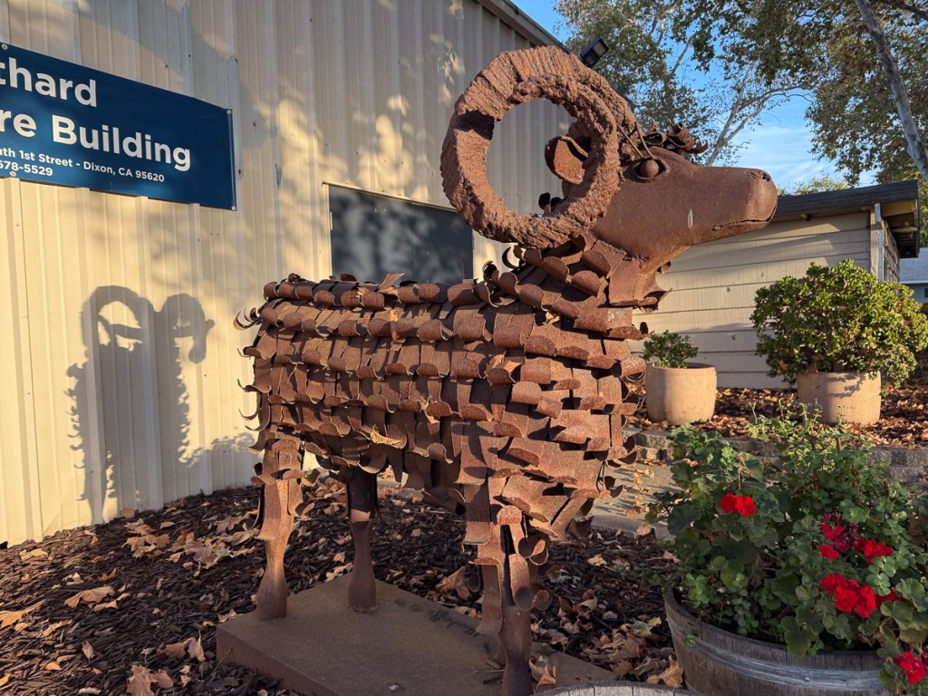 Metal sheep with two large horns.