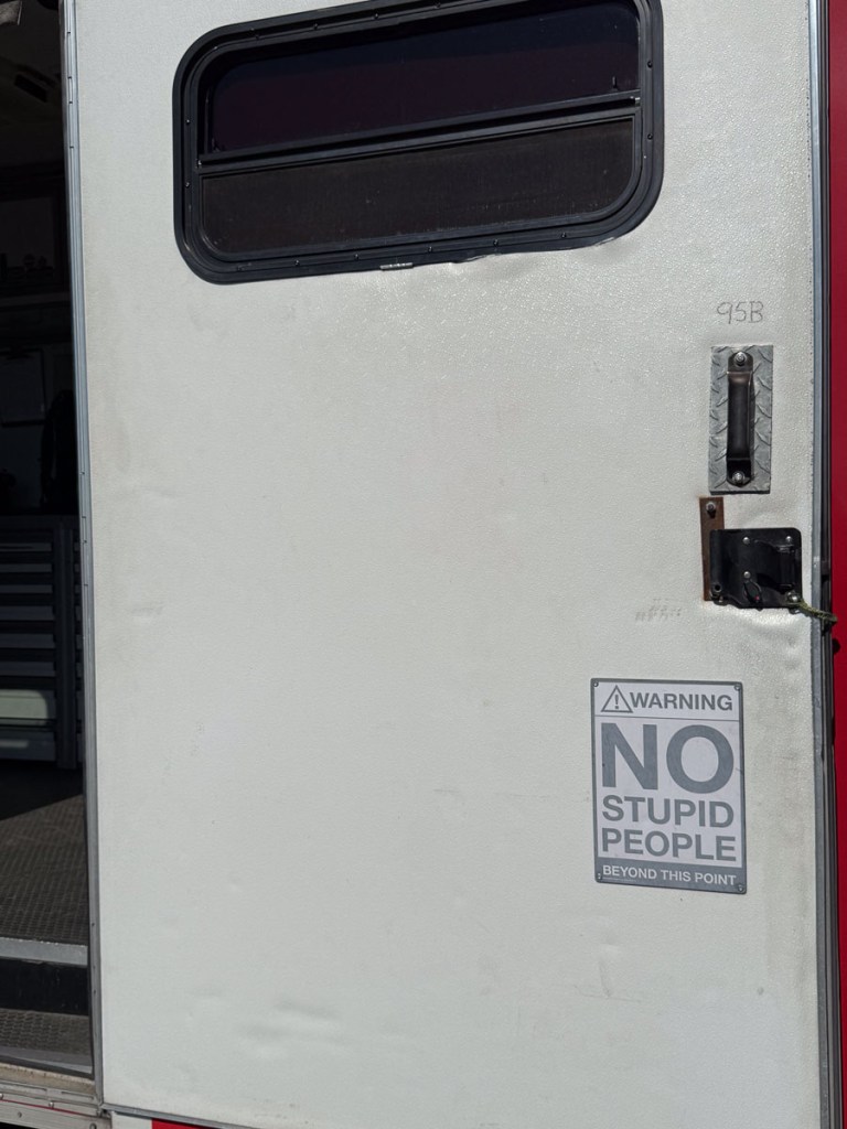 Door with sign that says "Warning. NO stupid people".
