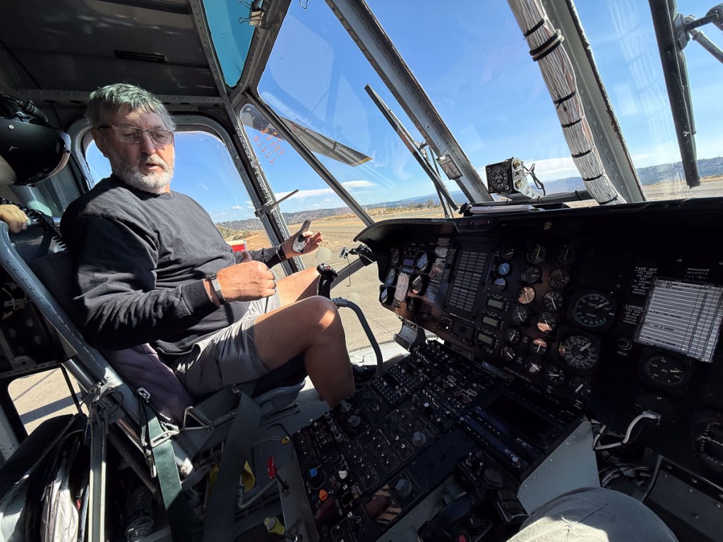 Dan sitting in the pilot seat of the sky-crane helicopter.