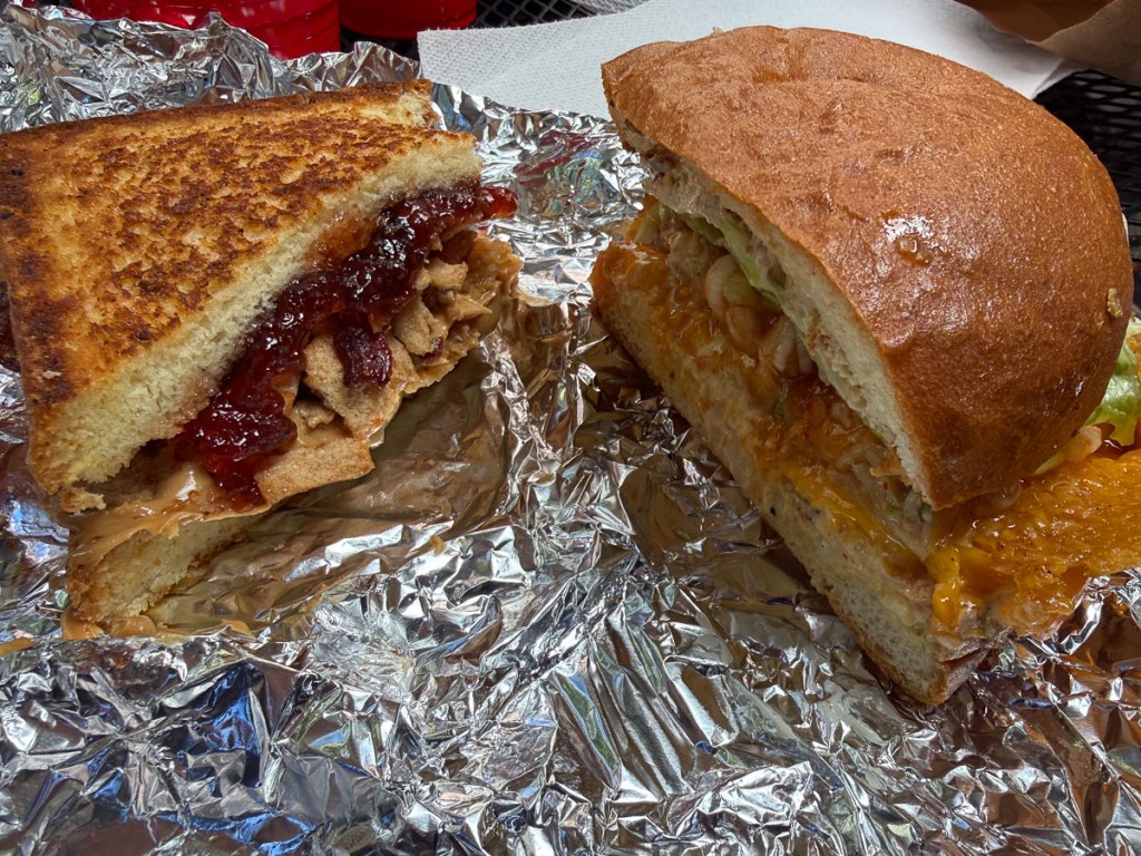 Two sandwich halves on aluminum foil.